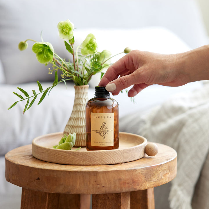image of hand grabbing lavender sage and mint on tray